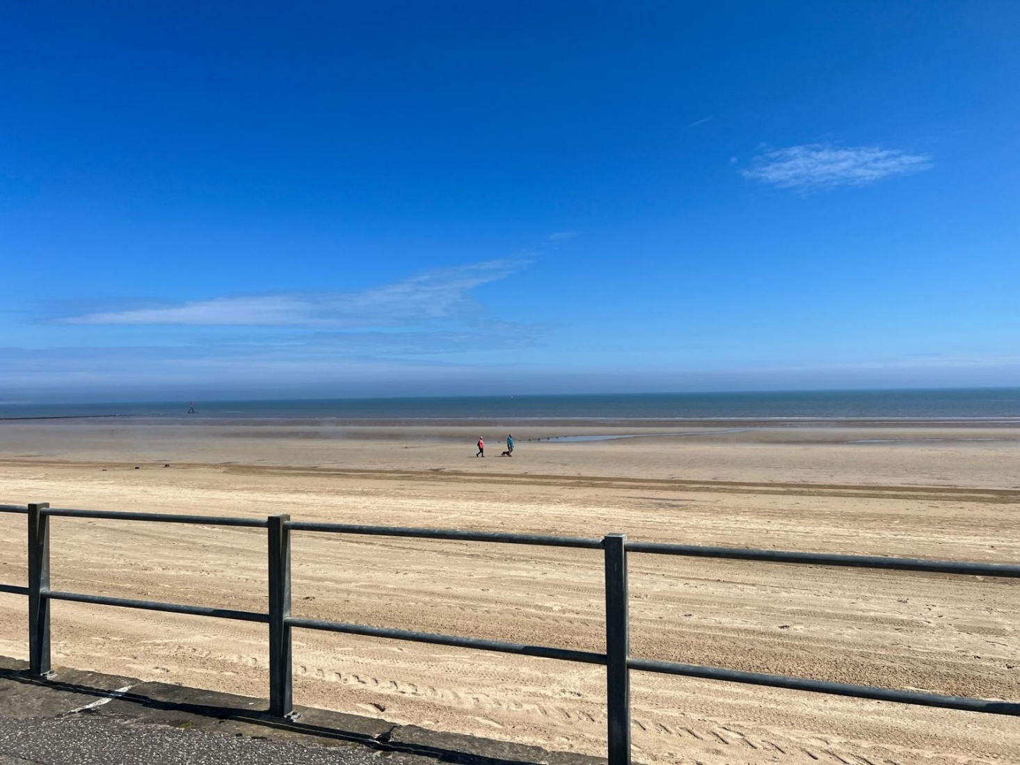 Bridlington beach with a bright blue sky