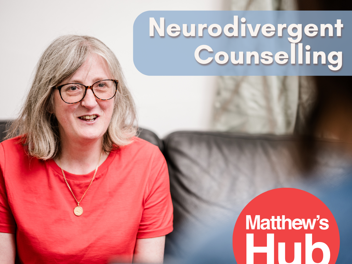 Neurodivergent Counselling. A woman in a red t-shirt and glasses talks to a woman in blue