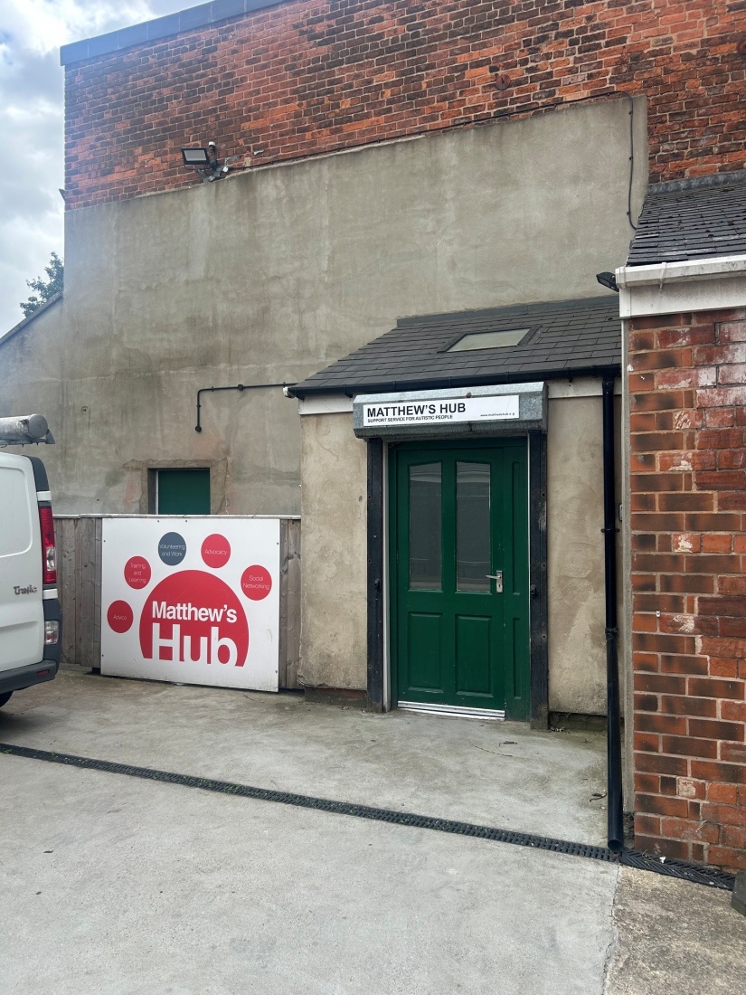 Matthews Hub Green Doorway with Red Sign on the left