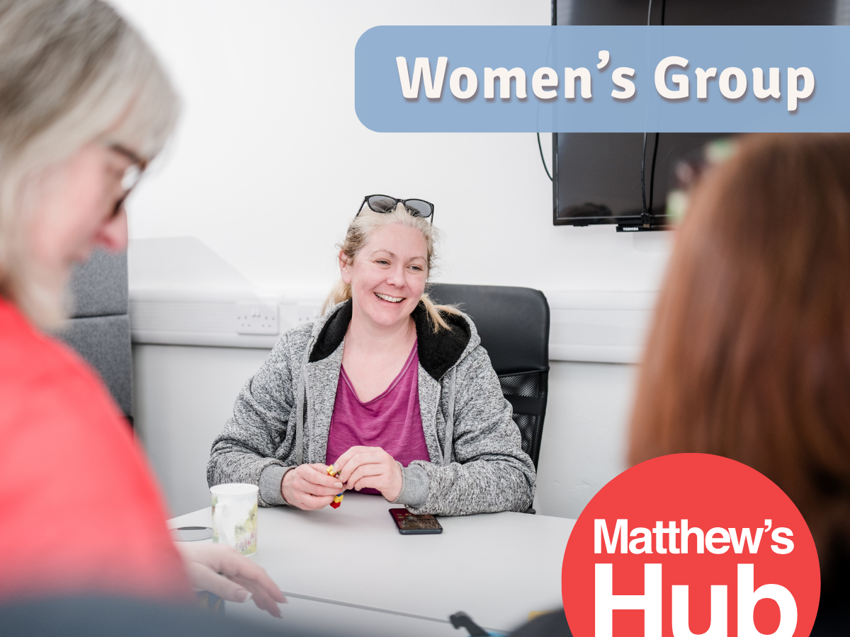 Women's group showing 3 members around a table